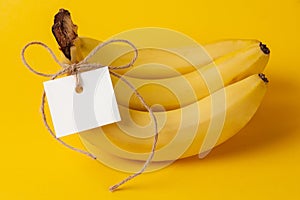 Bunch of ripe bananas with label on yellow