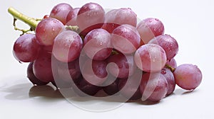 Bunch of ripe red grapes with leaves isolated on white.