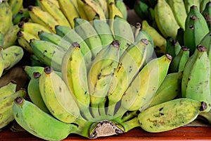 Bunch of ripe small bananas in a street market in Bangkok, Thailand. Horizontal picture