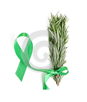 A bunch of rosemary on with a green ribbon on a white isolated, oncology symbol
