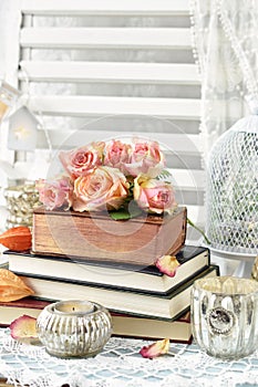 Bunch of roses lying on old books