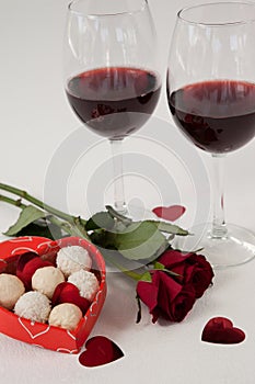 Bunch of roses, wine glasses and assorted chocolate box