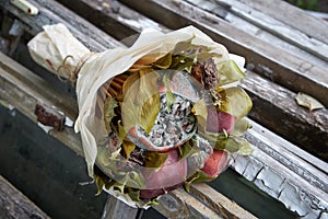 Bunch of rotten fruit and wilted flowers as a symbol of faded love