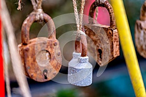 A bunch of rusty padlocks hanging from a string