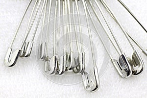 Bunch of safety pins on fabric