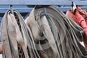 A bunch of securing belts for cargo loads on a tow trailer truck