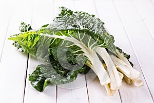 Bunch of silverbeet on a white wooden table