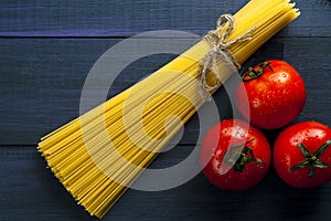 Bunch of spaghetti and three tomatoes