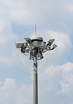 Bunch spot-light pole tower in blue sky