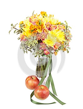 Bunch of spring flowers in a vase with apple isolated on white b