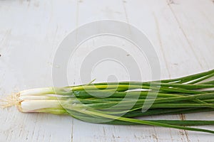 Bunch of spring onions on wooden