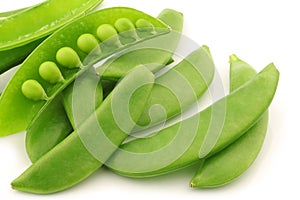 Bunch of sugar snaps with one opened pod photo
