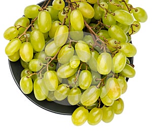 A bunch of table grapes in a plate on a white background isolated