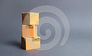 A bunch of three cardboard boxes. The concept of products and goods, commerce and retail. E-commerce, sales and sale of goods
