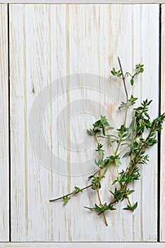 Bunch of thyme on the old wooden board top view