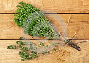 Bunch of thyme twigs isolated on wooden table