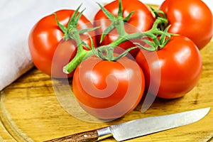 Bunch tomatoes on a cutting board
