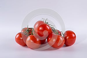 A bunch of tomatoes with drops of water