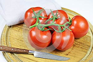 Bunch tomatoes on a cutting board