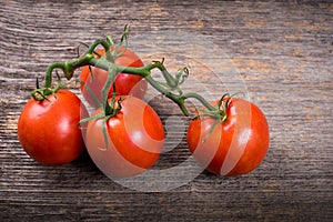 Bunch of tomatoes on the wooden table