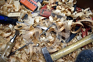 A bunch of tools on a messy workbench.