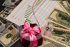 A bunch of US dollars in a pink ribbon, a beautiful background.