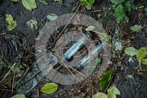 bunch of used dirty syringe leaved after drug injection lying on ground outdoor