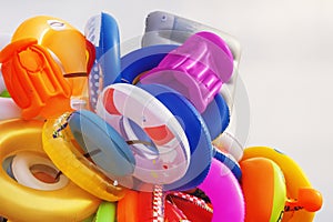 A bunch of various rubber rings and inflatable beach toys for swimming