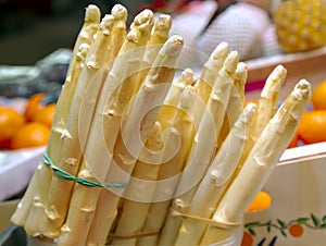 Bunch of white asparagus close up on vegetables market.