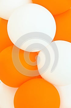 Bunch of white and orange air balloons. Kids birthday party decoration celebration fun concept.Abstract background template