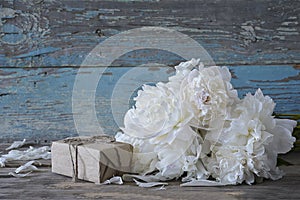 Bunch of white peonies and hand made gift box photo