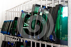 A Bunch of Windshields arranged on a shelf in Auto Shop