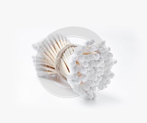 Bunch of wooden cotton buds tied with twine on a white background