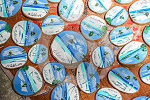 Bunch of wooden souvenirs with landscapes of Maldives on it