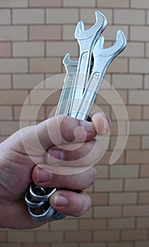 Bunch Of Wrenches In A Hand Of Mechanician Detailed Stock Photo