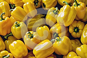 A bunch of yellow peppers are shown in a close up