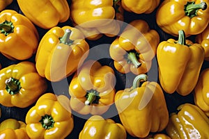 A bunch of yellow peppers are shown in a close up