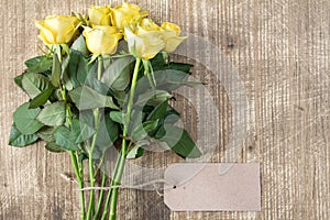 Bunch of yellow roses with blank tag