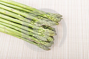 Bunches of asparagus tied on a burlap background