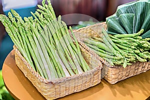 Bunches of asparagus on a wood background.