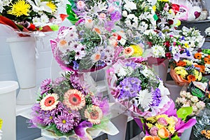 bunches of big fresh orange pink red gerbera chamomile and big white yellow blue chrysanthemum flower