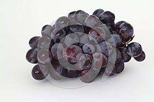 Bunches of dark grapes isolated on white background.