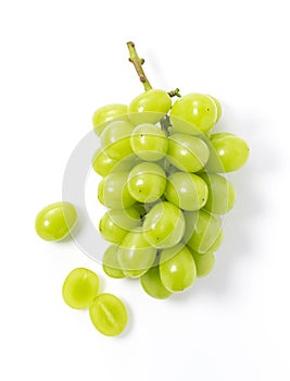 Bunches of Shine-Muscat grapes and cut Shine-Muscat grapes on a white background