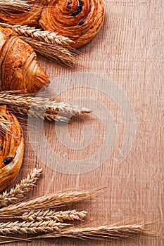 Bunches of wheat ears croissant rolls with raisins