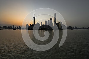 The Bund early in the morning at sunrise: View of Pudong and Huangpu river from The Bund in Shanghai, China