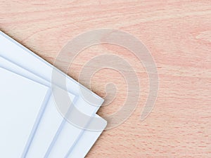 A bundle of blank white paper on wooden table.