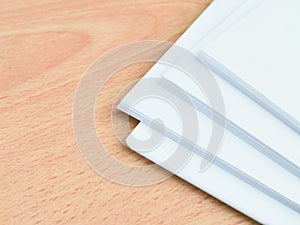 A bundle of blank white paper on wooden table.