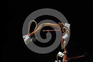 Bundle of computer wires on a black background. Connecting wires on a dark background