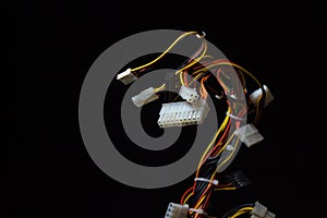 Bundle of computer wires on a black background. Connecting wires on a dark background