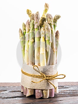 Bundle of cultivated white asparagus on wooden board. White background